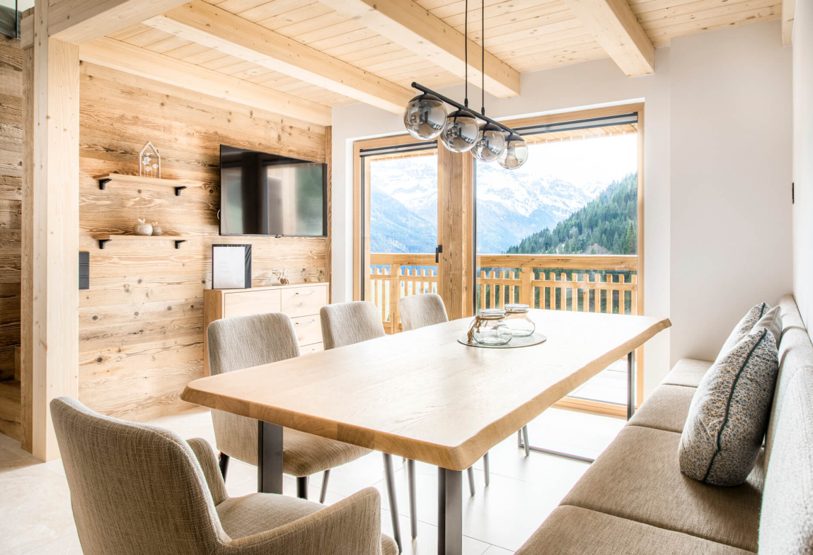 Modernes Esszimmer mit Holzinterieur und Aussicht auf die Berge in Kleinarl.